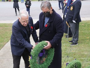Navy veteran Joe Reid (left) and his son Rick place a wreath at the Consecon Cenotaph during Remembrance Day ceremonies in the village Thursday morning. Reid, 101 (and a half) placed the wreath on behalf of of Second World War and Korean War veterans. BRUCE BELL