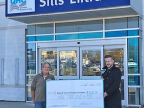 Lorne Holditch presents a cheque for $9,010 to Steve Cook, BGHF Executive Director. The funds were raised at Holditch's annual Deadnersville Halloween scarefest, which saw 3,700 visitors this year. SUBMITTED PHOTO