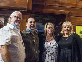 Greg and Nancy Annesley, far left and far right, former owners of the Boathouse Seafood Restaurant, pose alongside Tom and Crystal Mantis, middle, whom will now act as the new owners of the 21 year old Belleville waterfront staple. ALEX FILIPE