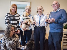 Donna Cunningham, seated, Kecia Matheson and Janet Marissen pose alongside Nancy and Jim Moore as they hold their Patrons Award from the Lions Foundation of Canada Dog Guides association. Thursday in Belleville, Ontario. ALEX FILIPE