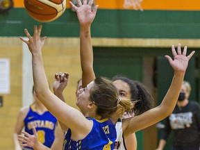 Keeleigh MacNeil of the BCI Mustangs launches a shot at the hoop in front of Steph Romany of the North Park Trojans during a senior girls basketball semi-final match on Thursday November 11, 2021 in Brantford, Ontario. Brian Thompson/Brantford Expositor/Postmedia Network