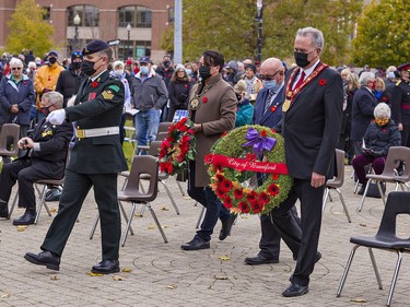 Six Nations elected chief Mark Hill (centre), councillor Brian Coleman of the County of Brant, and Brantford mayor Kevin Davis (right) carry wreaths to lay during Remembrance Day ceremonies on Thursday November 11, 2021 in Brantford, Ontario. Brian Thompson/Brantford Expositor/Postmedia Network