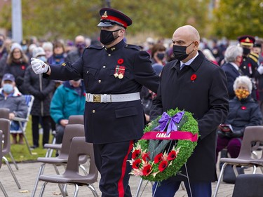 Brantford-Brant MP Larry Brock carries a wreath to the front of the Brant County War Memorial during Remembrance Day ceremonies on Thursday November 11, 2021 in Brantford, Ontario. Brian Thompson/Brantford Expositor/Postmedia Network