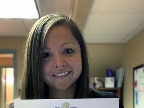 Jessica Powless, special events and public education co-ordinator at Nova Vita Domestic Violence Prevention Services, holds a Break The Silence Brant campaign card.