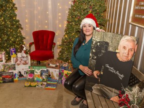 Holding a photograph of her father Ron Dawson, Danielle Dawson has organized a Dementia-friendly Christmas gift drive to benefit Alzheimer and Dementia patients at nursing homes in the Brantford area.