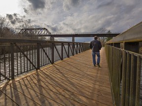 A man walks across the new East Gap bridge in Waterford, The bridge was installed November 10, 2021.