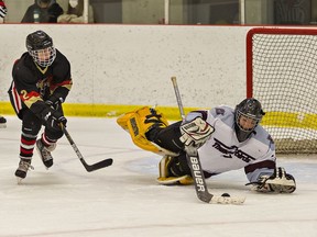 Pauline Johnson Thunderbirds goalie Ty Theriault reins in a loose puck before Nolan Carpenter of the Paris Panthers can get to it during a high school boys hockey game on Tuesday November 23, 2021 at the Brant Sports Complex in Paris, Ontario. Brian Thompson/Brantford Expositor/Postmedia Network