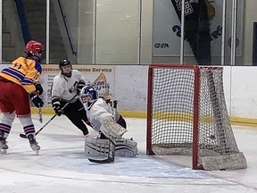 Alexia Hill of McKinnon Park Secondary School puts the puck past Pauline Johnson Collegiate goaltender Julia Coleman on Wednesday in an Athletic Association of Brant, Haldimand and Norfolk girls high school hockey game at the Haldimand County Caledonia Centre. Expositor Photo