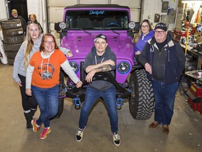 Brantford Area Jeep and Off Road Club president Kristin Shiplo (left) and members Rose Johnson, Jason Lavigne, Lisa Baker and Peter Baker (right) gather around Shiplo's 2005 Jeep TJ Rubicon on Wednesday November 24, 2021 in Brantford, Ontario.