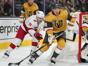 Vegas defenceman Ben Hutton is shown in the background as Golden Knights teammate Dylan Coghlan looks to clear the puck away from Carolina Hurricanes winger Jesper Fast during the third period at T-Mobile Arena on Tuesday night. Hutton picked up an assist in his second game with Vegas; Carolina won 4-2.
Stephen R. Sylvanie-USA TODAY Sports