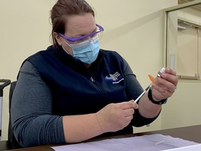 Robyn Phillips, a registered practical nurse at the Leeds, Grenville and Lanark District Health Unit, fills a syringe with the Pfizer COVID-19 vaccine at Brockville's vaccination clinic on Friday morning, Nov. 19, 2021. (RONALD ZAJAC/The Recorder and Times)
