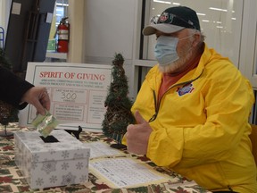 Spirit of Giving volunteer Kevin Hutt acknowledges another donation to the South Grenville-area Christmas program. Volunteers will be at O'Reilly's Your Independent Grocer in Prescott to accept donations on Saturday and Sunday. Tim Ruhnke/The Recorder and Times