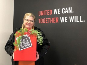 Courtney Wells, business liaison for United Way of Chatham-Kent, displays a sign promoting the 12 Days of Giving that began Nov. 1. Handout