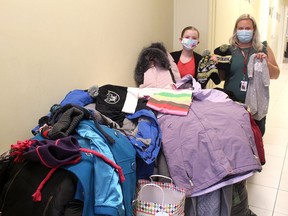 Twelve-year-old Grace Rumble organized a coat drive at St. Anne Catholic School in Blenheim, collecting 110 coats along with hats and scarves that were donated to the Operation Cover Up program run by Chatham-Kent Salvation Army. The Grade 7 student dropped off the coats on Wednesday to Allie Matthews, community and family services manager. Ellwood Shreve/Postmedia