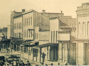 The City Hotel was located on the west side of the Market Square. It is the three-storey building with six windows in the front, towards the left side of the photo; circa 1875.
