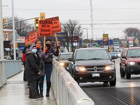 Some of the participants in the Zonta Says No campaign stand on the Parry Street Bridge in Chatham to take part in the annual rally to mark the International Day for the Elimination of Violence Towards Women on Nov. 25. Ellwood Shreve/Postmedia