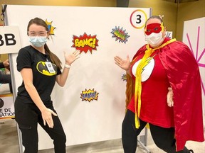 Summer Luu (Batman) and Trish Sullivan-Crew (The Flash) were among the super heroes at the first COVID-19 vaccination clinic for kids age five to 11, held at the Bradley Centre in Chatham on Nov. 27. Ellwood Shreve/Postmedia Network