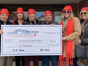 Members of the Sarnia-Lambton Real Estate Board gave a $2,000 cheque to the Inn of the Good Shepherd on Nov. 19 as part of the national Realtor's Care Week. From left to right: Sarnia-Lambton Real Estate Board executive officer Dave Burke, communications and public relations committee chair Kathy Murphy (Street City), committee member Melanie Kelders (Re/Max), the Inn's Myles Vanni, committee member Stephanie Dennis (Coldwell Banker). Handout/Sarnia This Week