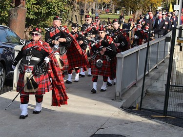 The Br. 642 Royal Canadian Legion Pipe Band leads a procession over the Sixth Street Bridge to begin a Remembrance Day ceremony at the cenotaph in downtown Chatham on Thursday. ELLWOOD SHREVE PHOTO/Chatham Daily News/Postmedia