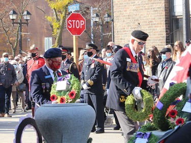 Eric Moulton, left, first-vice president of Br. 642 Royal Canadian Legion, and Len Maynard, Legion Zone A3 Commander, each lay reach for the legion branch and legion zone, respectively, during a Remembrance Day ceremony held at the cenotaph in downtown Chatham on Thursday. ELLWOOD SHREVE/Chatham Daily News/Postmedia