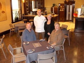 James Lizotte, left, and Thomas Smith, right, owners of Gentry Manor, are seated in Small Plates Restaurant, a new fine dining establishment they have recently opened. They are seen here with Chef Kevin DeSalliers and waitress Crystal Thibeault. ELLWOOD SHREVE Photo/Chatham Daily News/Postmedia