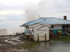 Wave spray flies over this property on Erie Shore Drive on Wednesday. Strong winds were sending waves pounding into the shoreline of the area, causing flooding in many places. The Lower Thames Valley Conservation Authority issued a flood warning Wednesday. ELLWOOD SHREVE PHOTO/Chatham Daily News/Postmedia