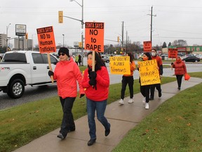 Some of the participants in the Zonta Says No campaign, walk towards the Parry Street Bridge in Chatham on Thursday to take part in the annual rally to mark the International Day for the Elimination of Violence Against Women. ELLWOOD SHREVE PHOTO/Chatham Daily News/Postmedia