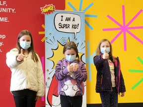 Avery Cowell, 9, left, and her sisters Olive, 7, middle, and Brooke, 9, are feeling good after getting their first COVID-19 vaccination shot at the first clinic for children ages five to 11 organized by Chatham-Kent Public Health on Saturday at the Bradley Centre in Chatham.