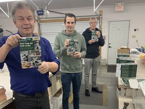 Author David Yates (left), graphic designer Kyle Vanderburgh (centre) and editor John Meyers holding copies of Time of Our Lives hot off the presses. Supplied
