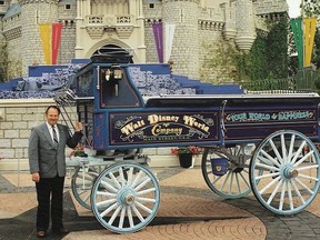 Wagon maker Tom Penhale beside his world-famous Disney Wagon at Disney World. Courtesy Wendy Johnston
