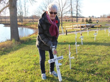 Rae Terriah places a cross at the Martintown Cenotaph, in memory of her father-in-law Roy Terriah. Photo on Wednesday, November 10, 2021, in Martintown, Ont. Todd Hambleton/Cornwall Standard-Freeholder/Postmedia Network