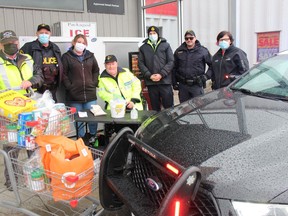 At the Stuff a Cruiser with Food Drive location at the Ingleside Foodland are, from left, Roland Dixon, SDG OPP Acting Staff Sgt. Greg Smith, Marianne Villemaire (House of Lazarus), Al Jodoin (Auxiliary OPP), Andrew Davidson (Auxiliary OPP), Const. Brad Looyen, and Kim Merkley (House of Lazarus client services manager). Photo on Saturday, November 13, 2021, in Ingleside, Ont. Todd Hambleton/Cornwall Standard-Freeholder/Postmedia Network