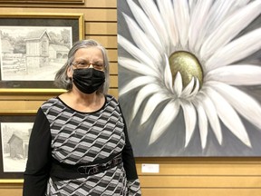 President of Focus Art Claudine Trottier standing next to her daisy art (right) on display at the first Focus Art exhibit since fall of 2019 on Tuesday November 16, 2021 in Cornwall, Ont. Shawna O'Neill/Cornwall Standard-Freeholder/Postmedia Network