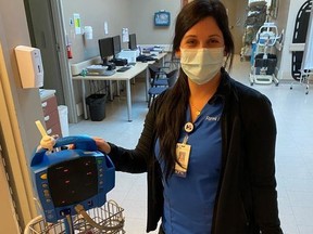 Handout/Cornwall Standard-Freeholder/Postmedia Network
Cornwall Community Hospital surgery unit registered practical nurse Jessica Wells, with a vital signs monitor that has been newly equipped with a radio-frequency ID tracking tag.