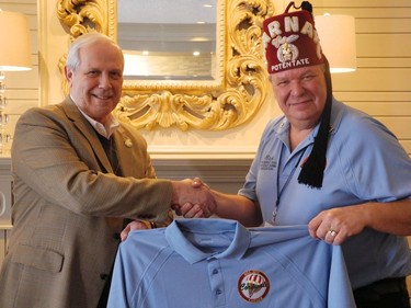 Sir. Rick Brousseau, president of the Northeast Shrine Association presents mayor Bob Kilger with a shirt during the Shriner's Mid Winter Meeting at the Ramada Inn and Conference Centre in Cornwall, Ont., on March 14, 2013. ERIKA GLASBERG/CORNWALL STANDARD-FREEHOLDER/QMI AGENCY