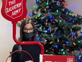 Owen Sound Salvation Army family services co-ordinator Alice Wannan stands with one of the organization's red kettles, which now also accept "tap" donations. SUPPLIED