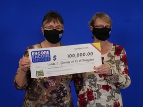 Linda Crosier and Mary Pickering of Kingston collect their winnings from matching six of the seven numbers, in order, in the Encore number on a Lotto 6/49 ticket.