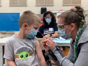 Alexander Tanguay becomes one of the first children aged five to 11 to receive the COVID-19 vaccine, in Napanee on Thursday.