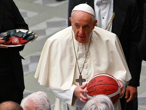 Pope Francis holds a basketball gifted by LIBA Italy (Legends International Basketball Association) during the weekly general audience at Paul VI Audience Hall in the Vatican on Nov. 3.