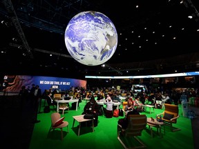 Delegates sit in the Action Zone as they attend the third day of the COP26 UN Climate Summit in Glasgow on Wednesday, Nov. 3, 2021.