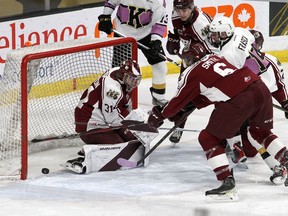 Kingston Frontenacs forward Jordan Frasca gets the puck past Peterborough Petes goaltender Michael Simpson as Konnor Smith tries to help in Ontario Hockey League action at the Leon's Centre on Friday.