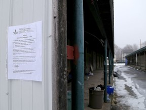 Signs posted at the Memorial Centre barns on Tuesday ban the construction or use of structures or tents in the area after a recent fire on the premises. Ian MacAlpine/The Kingston Whig-Standard/Postmedia Network