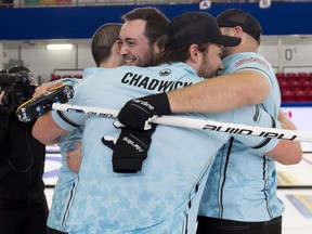Skip Tanner Horgan of Sudbury is surrounded by Kingston curling teammates Scott Chadwick, Wes Forget and Jon Beuk after winning the B final in an pre-Olympic Trials event in Liverpool, N.S., on Sunday.