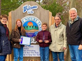 Lauren Tuckey, second from left, and Benson Tuckey, third from left, recently received a Rotary Outstanding Service Award for their efforts in the community. Also pictured are Grand Bend Rotary Club president Susan Moore, far left, one of the creators of the Rotary Trail Peter Warner, second from right, and Rotary secretary Kerry Teskey, far right.