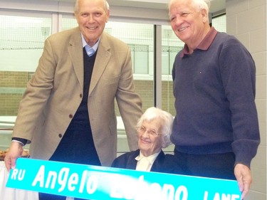 Cornwall Mayor Bob Kilger presents a replica of the Lebano Way street sign to Angelo Lebano's widow Mona and one of their sons, Donald, during a ceremony at the Benson Centre, Friday, Dec. 9, 2011. GREG PEERENBOOM/CORNWALL STANDARD-FREEHOLDER/QMI AGENCY