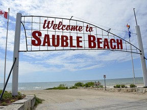 To the south (left) of this sign at Sauble Beach is the northeast corner of Saugeen First Nation. The band is claiming a stretch of of beach north of the sign, to about the large washroom building at 6th Street.