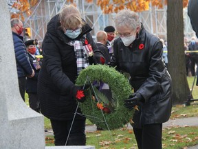 Escorted by her daughter Eileen Robson, the 2021 Silver Cross Mother representative for Pembroke Thelma Henshaw lays a wreath at the cenotaph on Remembrance Day. Anthony Dixon