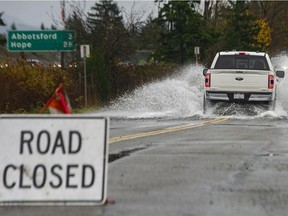 Drivers brave the flooded road on South Fraser Way near Townline Road, parallel to Highway 1, in Abbotsford on Sunday, Nov. 28, 2021.