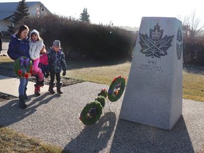 Serene Cotterhill and her kids Callie, Aubree and Breanna laid a wreath at the cenotaph following the outdoor Remembrance Day ceremony in 2021.