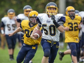 College Avenue Knights ball carrier Aidan George puts distance between himself and Montcalm Cougar Owen Dixon during their Thames Valley Regional Athletics varsity football game in Woodstock this season. The Knights won the game 58-0.